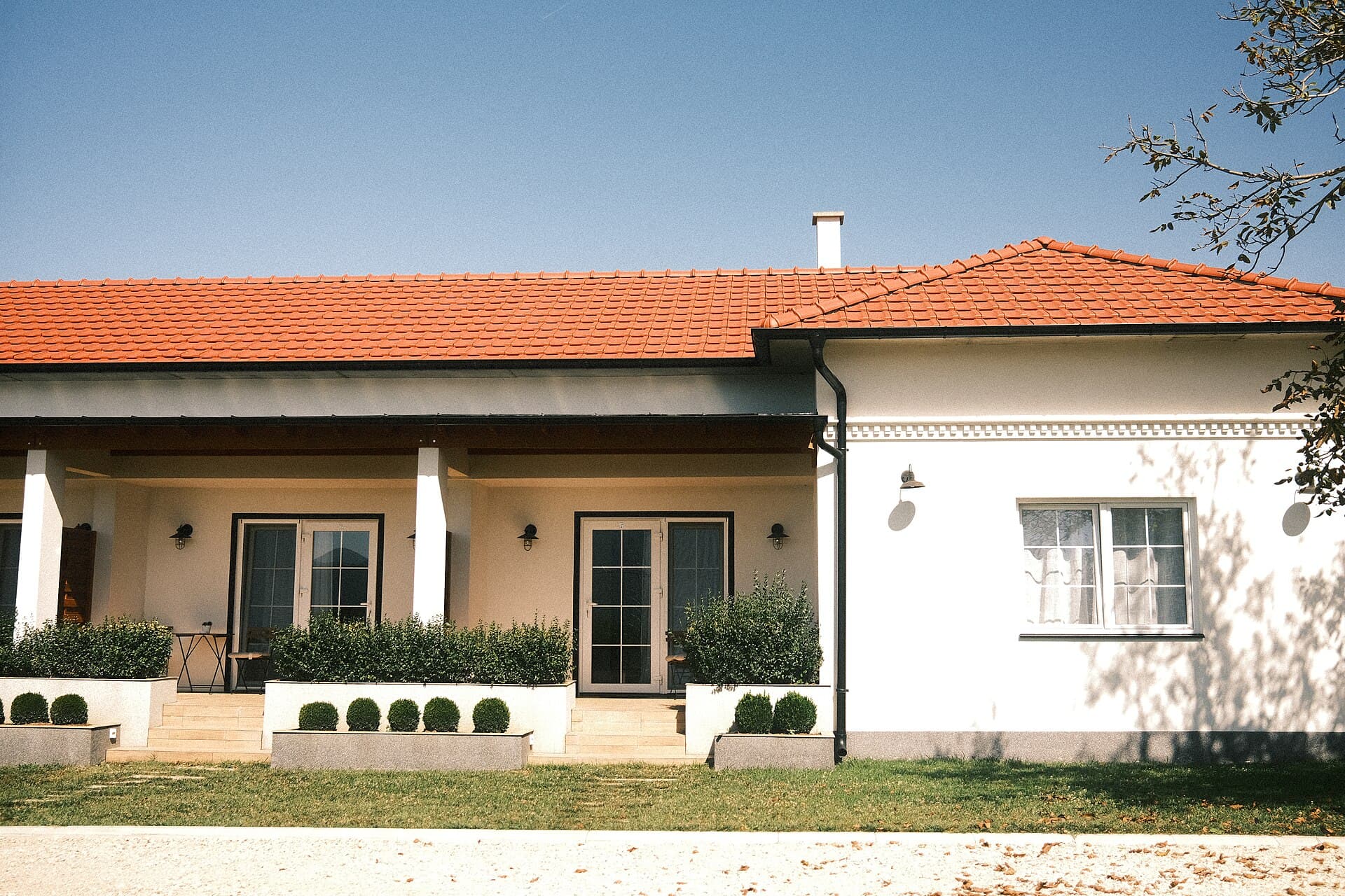 Modernes Einfamilienhaus mit gepflegtem Garten unter blauem Himmel